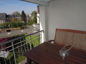 a tea pot sitting on a wooden table on a balcony at Ferienwohnung Ein Zuhause auf Zeit in Lübeck