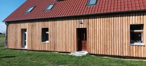 a large wooden building with a red roof at Fürstenau 29 in Fürstenau +3 photos