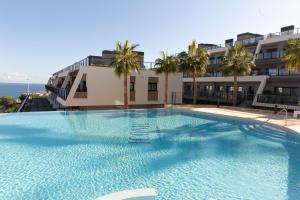 a large swimming pool in front of a building at Casa Neroli ICONIC Gran Alacant in Gran Alacant