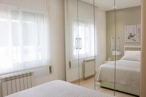 a bedroom with two beds and a glass wall at Cozy Apartment Rocamar in Sant Pere de Ribes +10 photos