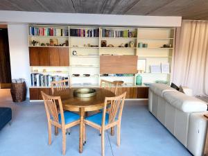 a dining room with a table and a couch at Sweet Valley Cozy in Zutendaal +17 photos