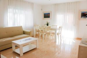 a living room with a couch and a table at Cozy Apartment Rocamar in Sant Pere de Ribes