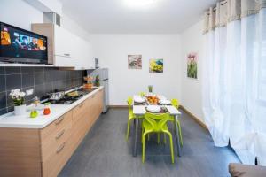 a kitchen with a table and some yellow chairs at Residence Near The Sea - Abruzzo in Martinsicuro +15 photos