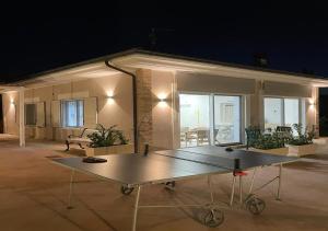 a ping pong table in front of a house at night at Casa Adriano-Dimora per vacanze in Ripa Teatina