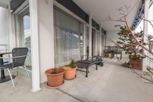 a balcony with chairs and plants on a building at Sunnagarta in Davos