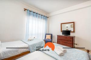a bedroom with two beds and a dresser and a mirror at #258 Travessa do Mar F by Home Holidays in Albufeira