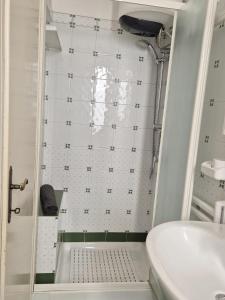 a small bathroom with a shower and a sink at Casa Naldina in Marciana Marina +17 photos