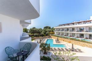 a view of the pool from the balcony of a hotel at Inturotel Cala Esmeralda Beach Hotel & Spa - Adults Only in Cala d´Or