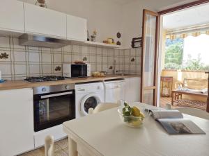 a kitchen with a table and a stove top oven at Casa Naldina in Marciana Marina