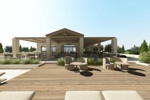 a wooden deck with chairs and a gazebo at The Yard Corfu Boutique Hotel and Spa in Corfu Town