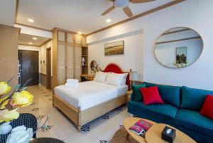 a hotel room with a bed and a couch at Otis Soho Saigon Balcony Apartment in Ho Chi Minh City