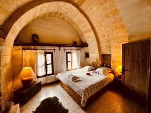 A bed or beds in a room at Les Maisons De Cappadoce