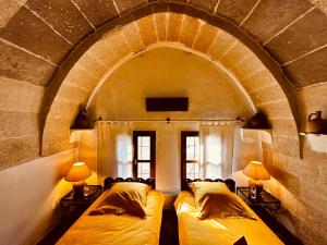 A bed or beds in a room at Les Maisons De Cappadoce