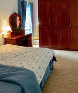 a bedroom with a bed and a dresser and a mirror at An Yên Homestayy huế in Thôn Lại Thê