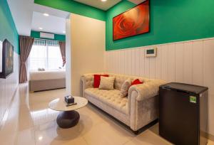 a living room with a couch and a table at Otis Soho Saigon Balcony Apartment in Ho Chi Minh City