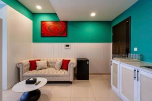 a living room with a couch and a table at Otis Soho Saigon Balcony Apartment in Ho Chi Minh City