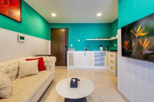 a living room with a couch and a table at Otis Soho Saigon Balcony Apartment in Ho Chi Minh City