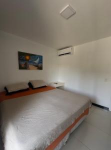 a bedroom with a bed in a white room at Eco Paradise Apto 214 in Caucaia +6 photos