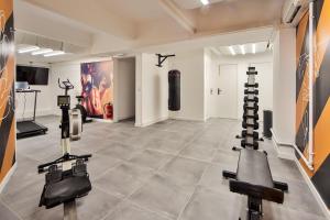 a gym with several exercise equipment in a room at 10 Studio Charenton Chambre Fitness Cinema in Charenton-le-Pont