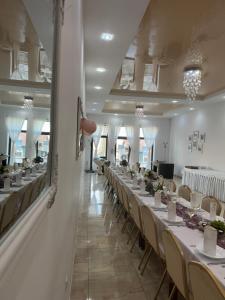 a long row of tables in a banquet hall at Nostalgia restaurant & pension in Rimavská Sobota