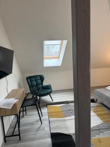 a room with a bed and a desk and chairs at Nostalgia restaurant & pension in Rimavská Sobota