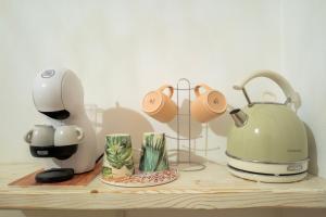 a counter with a mixer and a tea kettle on it at Dimore Piazza Vecchia Wellness Suites in Castellana Grotte