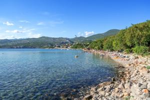 a group of people on a beach in the water at Camping Klenovica in Klenovica