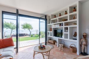 a living room with a couch and a table at Demeure d'exception vue mer in Andernos-les-Bains