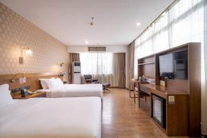 Voodi või voodid majutusasutuse Xicheng International Hotel Guangzhou Sanyuanli Jiangxia Metro Station Branch toas