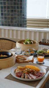 a table with a plate of food on a table at Arco Phuket Town in Phuket Town