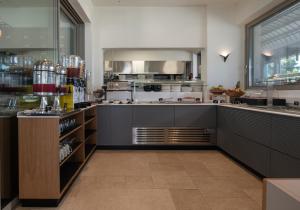 a large kitchen with stainless steel appliances at Oniro Boutique Hotel in Toroni