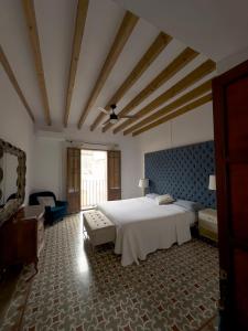 a bedroom with a large white bed and a couch at Casa Mona, Turismo de Interior in Llubí