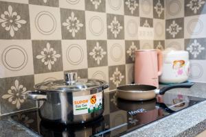 a pot sitting on top of a stove in a kitchen at Otis Soho Saigon Balcony Apartment in Ho Chi Minh City
