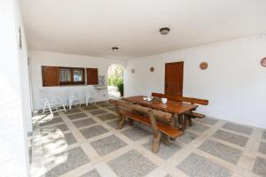 a dining room with a wooden table and chairs at Calsina Baix 2H in Pals +13 photos
