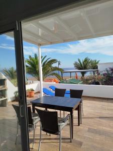 Una mesa y sillas en un patio con vista al mar. en Escapada de ensueño Conchaseaview, en Playa Honda 17 fotos más