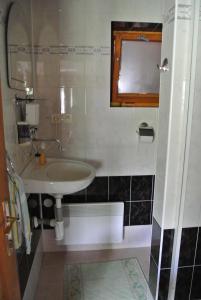 a bathroom with a sink and a mirror at Apartmán Margarétka in Liptovský Trnovec
