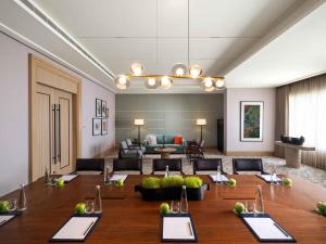 a large room with a table and a couch at Pullman Chennai Anna Salai - Premium Brand By Accor in Chennai