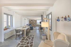 a living room with a table and a dining room at Villa Vireya in Naousa
