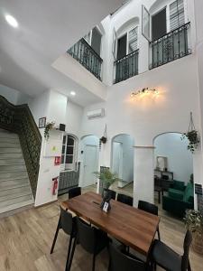 a living room with a wooden table and chairs at Triana Riverside in Seville +100 photos