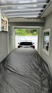 a garage with a car wrapped in plastic in it at Casa aconchegante in Rio das Ostras