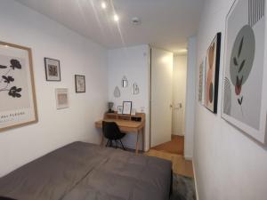 a bedroom with a bed and a desk in it at SO Maison Petite in Augsburg