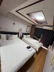 two beds in a hotel room with at 日韓マンション305 in Tokyo