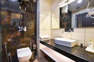 a bathroom with a sink and a toilet at AH Grand Villa - Hotel Near Dalai Lama Temple in McLeod Ganj