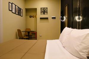 a hotel room with a bed and a table at BlackWoody Contemporary Rooms - Napoli Centro Storico Via Toledo in Naples