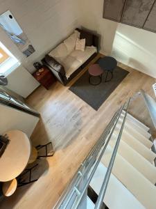an overhead view of a living room with a couch and a table at Charmant studio indépendant in Oinville-sur-Montcient