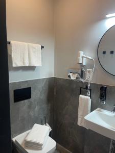 a bathroom with a sink and a toilet and a mirror at Motel Blue Messe in Berlin