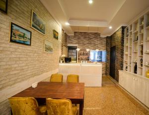 a dining room with a table and chairs and a kitchen at Aura Boutique Hotel in Batumi