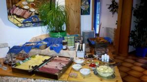 a table with a buffet of food on it at Pension Aufeld in Landsberg am Lech