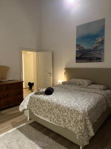 a bedroom with a bed with a cat laying on it at Casa Leoni Chianni - tuscan luxurious Villa in Chianni +48 photos