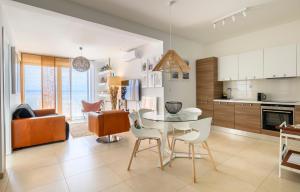 a kitchen and living room with a table and chairs at Gallery Luxury Suites & Rooms-Only Adults in Split